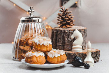 table with cup of coffee and  cupcake in glaze light background