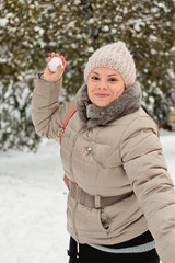 Girl throws snowballs