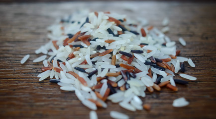 Close-up multi-colored sprinkle rice on the wooden table