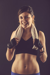 Fototapeta na wymiar Sporty Young Woman Grinding Teeth on Black Background.