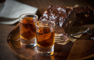 Glass of rum on wooden tray
