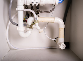 Pipes and plumbing under sink