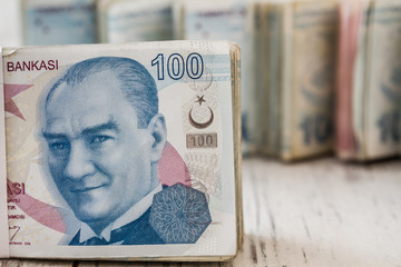 Bunch of Turkish Lira Banknotes on White Wooden background