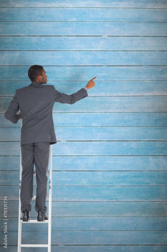Aufkleber composite image of businessman standing on ladder pointing