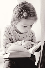 toddler with book