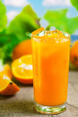 Orange juice in glass, fresh cold drink with ice