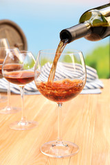 Red wine pouring into wine glass, close-up