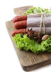 Smoked thin sausages  with lettuce salad leaves and spices