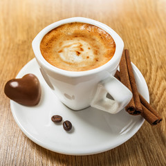 Coffee with candy heart and cinnamon