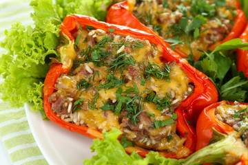 Stuffed red peppers on plate on napkin close up