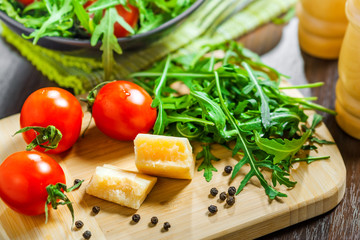 Healthy food, tomato rucola and Parmesan salad cooking