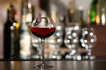 Glass of wine with bar on background