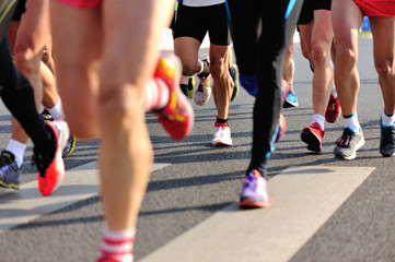 marathon runner legs running on city street