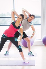 Obraz premium Two people doing power fitness exercise at yoga
