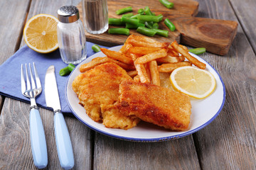 Breaded fried fish fillets and potatoes with asparagus and