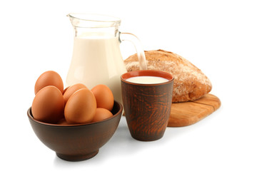 Milk, eggs and loaf of bread isolated on white