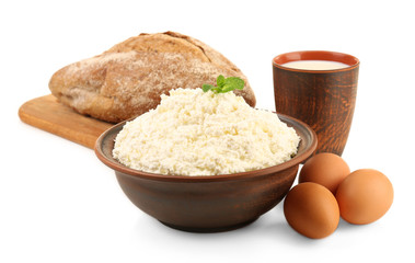 Dairy products with eggs and loaf of bread isolated on white