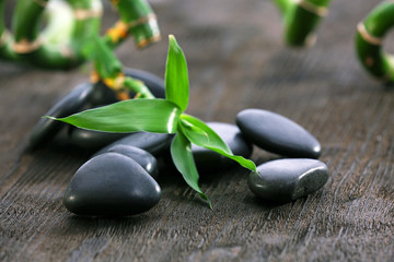 Stack of black sea paddles with bamboo trunks