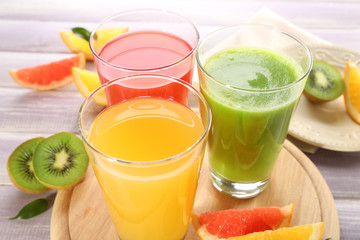 Fresh juices with fruits on wooden table