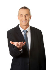 Businessman holding something on his palm