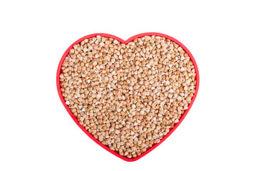 Buckwheat in a bowl in the shape of heart.