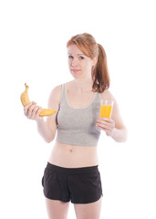Athletic girl with a banana and juice in hand