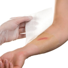 Medical assistant changes the dressing of a wound at the