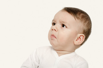 Cute baby boy looking up upset. Baby looking disgusted. - 78342953