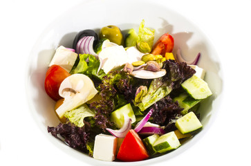Greek salad on a white background in the restaurant