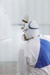 Automobile repairman painter paints the details for body repair