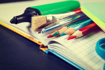 School supplies on black background, vintage color tone