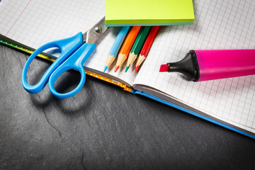 School supplies on black background