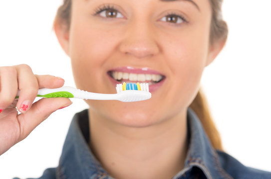beautiful young smiling woman brushing teeth