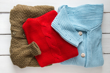 Stack of women's  sweaters and cardigans.