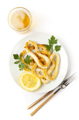 fried squids with cold beer & lemon on white