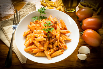 Penne with pork meat and tomato sauce, Italian cuisine