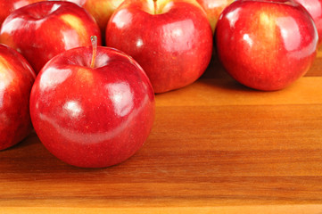Red tasty apples on wooden table