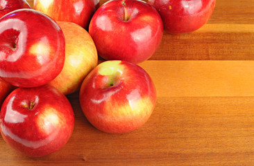 Red tasty apples on wooden table