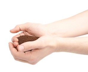 Two hands holding a handful of ground soil