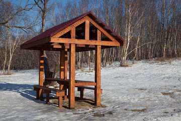Fototapeta na wymiar Picnic pavilion in winter forest