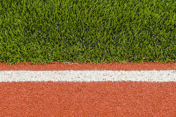 Detail of running track rubber lanes with the artificial grass.