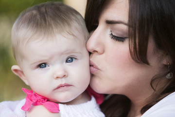 woman kissing baby