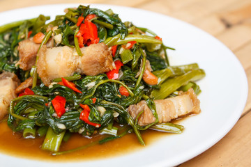 Fried morning glory with crispy pork.