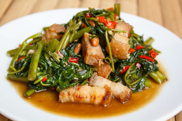 Fried morning glory with crispy pork.