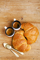 two hot croissant & two cup of fresh coffee espresso on wood bac