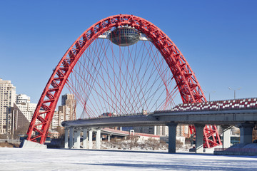 Red bridge over the frozen Moskva river, Moscow, Russia