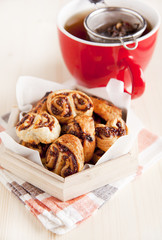 Natural tea with puff pastries and fig jam . Tea strainer in cup