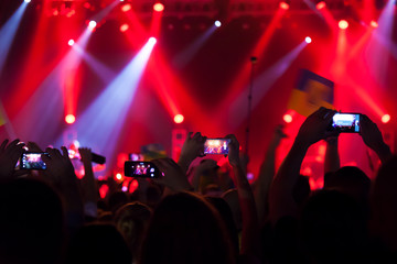 People at concert shooting video or photo.