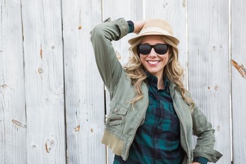Portrait of blonde in hat posing with sunglasses