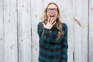 Surprised blonde in striped shirt gesturing